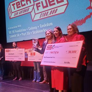 Rectify's cofounders Melissa Unsell-Smith and Lisa McComb accept the $50,000 grand prize awarded to them during the TechFuel pitch competition held by Tech Bloc and Bexar County.