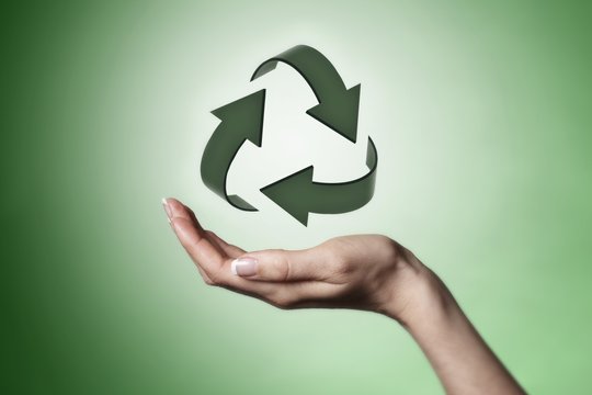 Hand holding recycle symbol