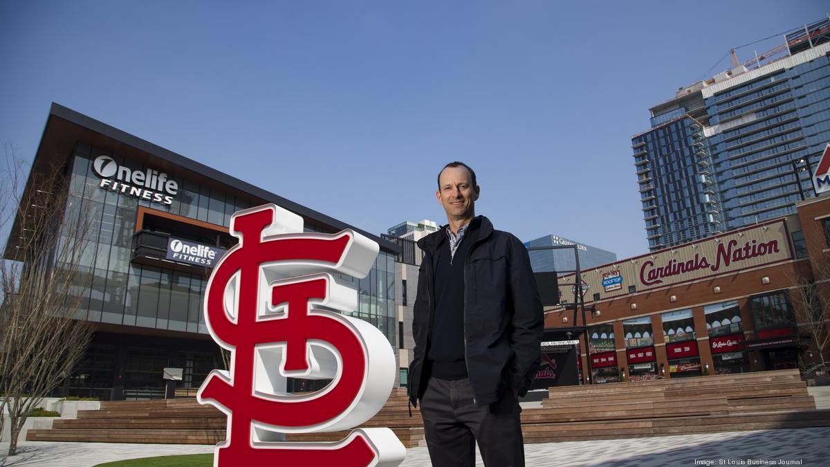 St. Louis Cardinals President Bill DeWitt III (R) points out the