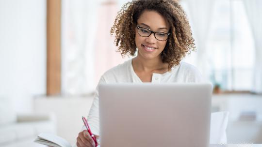 Young black woman working at home