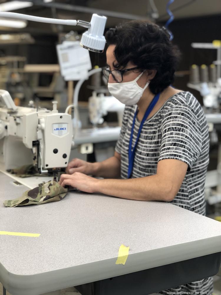 An employee at Industries of the Blind in Greensboro sews a face mask that will be used by a soldier in the U.S. Army.