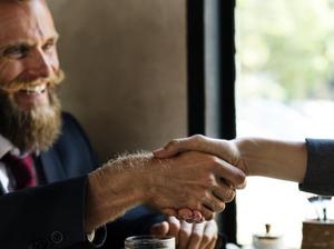 Business agreement handshake at coffee shop