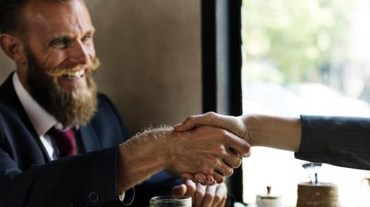 Business agreement handshake at coffee shop