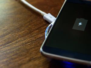 Smartphone charging on a charging pad. Wireless charging