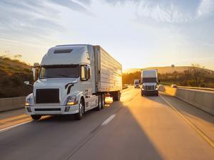 semi truck 18 wheeler sunrise on highway