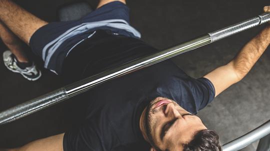 Young man doing bench press exercise