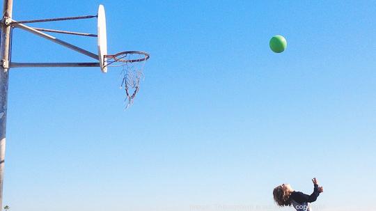 Boy shooting hoops on basketball court, California, America, USA