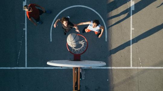 Overhead view of friends on basketball court playing basketball game