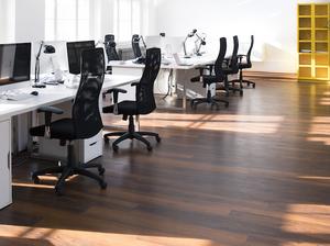 Desks with PCs in bright and modern open space office