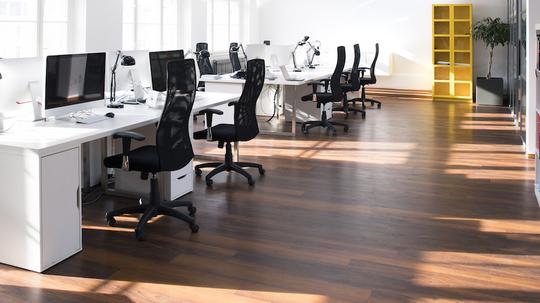 Desks with PCs in bright and modern open space office