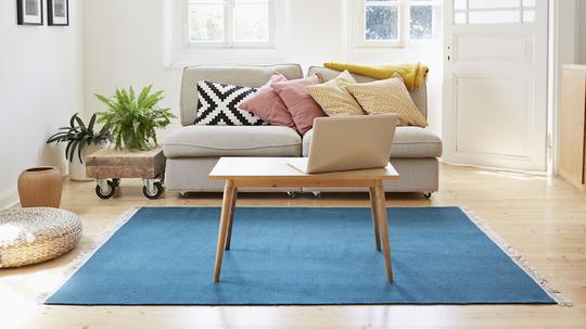 Laptop on coffee table in a modern living room of an old country house