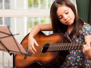 Girl plays guitar (image via Care2Rock)