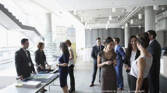 Business people networking and checking in at conference