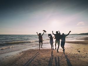 Asian family running on beach