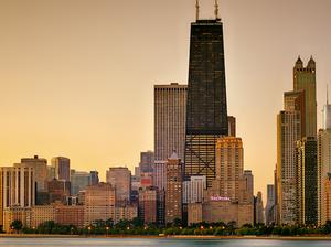 View Of City At Waterfront During Sunset