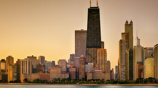 View Of City At Waterfront During Sunset