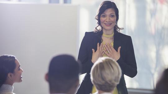 Businesswoman gesturing, leading conference meeting