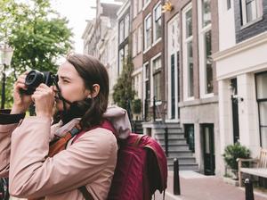 Woman taking photo  on the streets  of Amsterdam