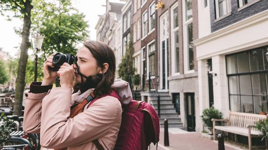 Woman taking photo  on the streets  of Amsterdam