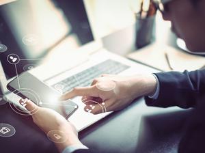 Businessman hand working with mobile phone and laptop computer  with technology digital graphic