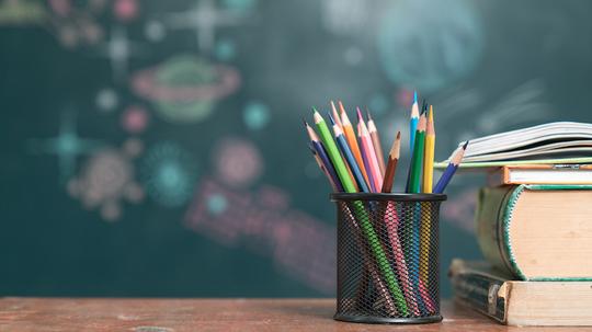 School books on desk, education concept