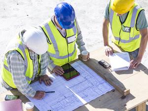 Builder and architect  on building site