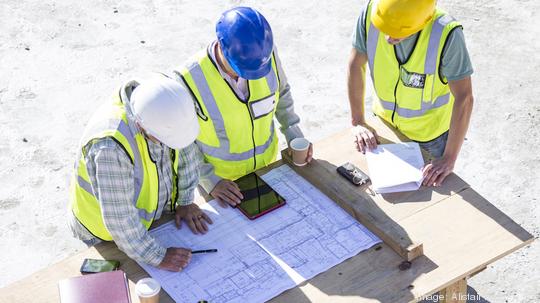 Builder and architect  on building site