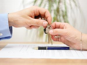 real estate agent gives house keys to his client