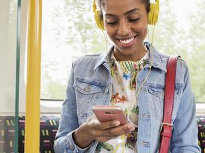 Woman using her phone on a train