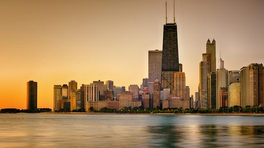 View Of City At Waterfront During Sunset