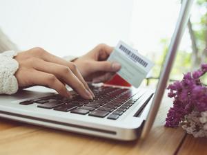 Cropped Hands Of Woman Making Card Payment While Using Laptop At Table