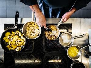 Aerial Shot Of Chef Cooking On The Hob In Restaurant Kitchen