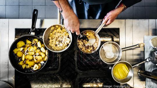 Aerial Shot Of Chef Cooking On The Hob In Restaurant Kitchen