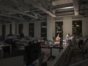 Mixed race businesswoman working late in office