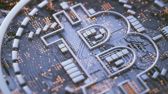 Bitcoin logo on circuit board, illustration