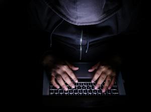 hacker Man with laptop stealing perdonal data from internet