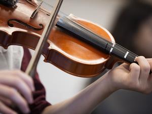 Caucasian student musician playing violin