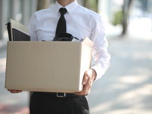 Close-up Of Unemployed Businessperson Carrying Cardboard Box