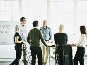 Group of architects having project meeting in design studio conference room