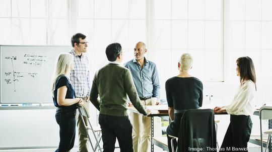 Group of architects having project meeting in design studio conference room