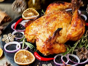 Turkey in roasting pan on table for holiday meal