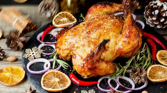 Turkey in roasting pan on table for holiday meal