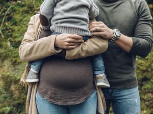 Pregnant woman with family in nature