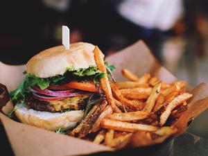 Close-Up Of Burger With French Fries On Table