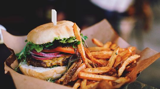 Close-Up Of Burger With French Fries On Table