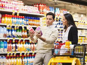 Hispanic couple shopping in grocery store