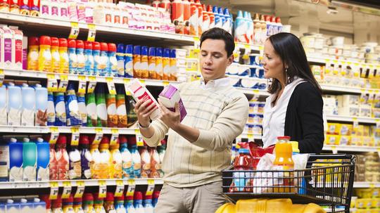 Hispanic couple shopping in grocery store