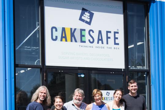 group outside with cakesafe sign - generous cropping