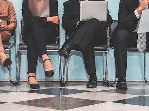 Low Section Of People Waiting For Interview On Chair