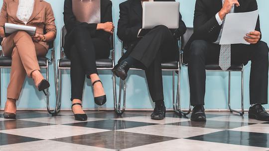 Low Section Of People Waiting For Interview On Chair